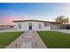 Charming home with gravel landscaping, a walkway, a minimalist lawn and a black trimmed flat roof at 7802 E Kimsey Ln, Scottsdale, AZ 85257