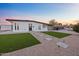 Charming home with gravel landscaping, a walkway, a minimalist lawn and a black trimmed flat roof at 7802 E Kimsey Ln, Scottsdale, AZ 85257