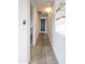Hallway with wood floors and white walls leading into multiple rooms at 7802 E Kimsey Ln, Scottsdale, AZ 85257