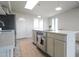 Bright kitchen featuring an island with cooktop, stainless steel appliances, and a door to the exterior at 7802 E Kimsey Ln, Scottsdale, AZ 85257