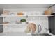 Modern kitchen featuring a stainless sink, shelving, a white subway tile backsplash and ample counter space at 7802 E Kimsey Ln, Scottsdale, AZ 85257