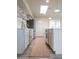 Contemporary kitchen featuring modern appliances, open shelving, and a seamless design that leads to the backyard at 7802 E Kimsey Ln, Scottsdale, AZ 85257