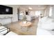 Open-concept living room with a modern design, island, sleek countertops, and stainless steel appliances at 7802 E Kimsey Ln, Scottsdale, AZ 85257