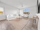 Comfortable living room featuring a white sofa, light wood floors and a view to the exterior at 7802 E Kimsey Ln, Scottsdale, AZ 85257