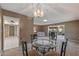 Cozy dining area with carpet, a modern chandelier, and seamless access to the living spaces at 10449 W Tropicana Cir, Sun City, AZ 85351