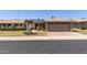 Single-story home with solar panels, desert landscaping, and a brick driveway at 10449 W Tropicana Cir, Sun City, AZ 85351