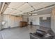 Spacious garage featuring a finished floor, built-in storage cabinets and a comfortable chair at 10449 W Tropicana Cir, Sun City, AZ 85351