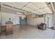 Spacious garage featuring a finished floor, built-in storage cabinets and a comfortable chair at 10449 W Tropicana Cir, Sun City, AZ 85351