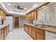 Bright kitchen featuring tile flooring, plentiful cabinetry, and modern appliances at 10449 W Tropicana Cir, Sun City, AZ 85351