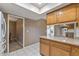 Bright kitchen space with tile flooring, granite countertops, and access to a laundry room at 10449 W Tropicana Cir, Sun City, AZ 85351