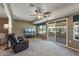 Relaxing living room with a comfortable recliner, large TV, and access to an outdoor patio at 10449 W Tropicana Cir, Sun City, AZ 85351