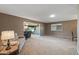 The living room has carpeted floors and leads to other seating areas within the home at 10449 W Tropicana Cir, Sun City, AZ 85351