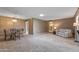 Open-concept living room featuring a dining area and comfortable seating, ideal for gatherings and relaxation at 10449 W Tropicana Cir, Sun City, AZ 85351