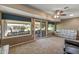 Bright living area with sliding glass doors to the outdoor patio and cozy furnishings at 10449 W Tropicana Cir, Sun City, AZ 85351