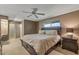 Spacious bedroom features ceiling fan, carpet flooring, and lots of natural light at 10449 W Tropicana Cir, Sun City, AZ 85351
