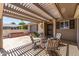 Inviting covered patio area featuring comfortable seating, perfect for relaxing outdoors at 10449 W Tropicana Cir, Sun City, AZ 85351