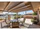 Inviting covered patio featuring a stylish outdoor dining set, perfect for entertaining guests at 10449 W Tropicana Cir, Sun City, AZ 85351