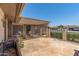 Covered patio with stone flooring and comfortable seating offers a relaxing outdoor space at 10449 W Tropicana Cir, Sun City, AZ 85351