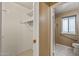 Walk-in closet leading to bathroom offers shelving and generous storage space at 10449 W Tropicana Cir, Sun City, AZ 85351