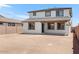 Backyard view of the two story home with a blank canvas ready for landscaping at 10912 E Tiburon Ave, Mesa, AZ 85212