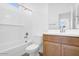 Bathroom featuring a shower-tub combo, white subway tile surround and light wood vanity at 10912 E Tiburon Ave, Mesa, AZ 85212