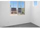 Minimalist bedroom featuring a window overlooking the neighborhood and plush carpeting at 10912 E Tiburon Ave, Mesa, AZ 85212