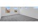 Bright bedroom with multiple windows and plush gray carpeting, offering natural light and comfort at 10912 E Tiburon Ave, Mesa, AZ 85212