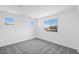 Neutral bedroom featuring gray carpet and bright light from the large windows at 10912 E Tiburon Ave, Mesa, AZ 85212
