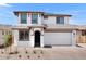 Charming two-story home boasts a neutral exterior with a two-car garage and well-manicured landscaping at 10912 E Tiburon Ave, Mesa, AZ 85212