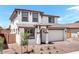 Charming two-story home boasts a neutral exterior with a two-car garage and low-maintenance landscaping at 10912 E Tiburon Ave, Mesa, AZ 85212