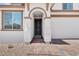 Inviting entryway featuring a dark wood door, brick walkway, and an attached two car garage at 10912 E Tiburon Ave, Mesa, AZ 85212