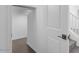 Hallway displaying tile floors, neutral paint and a door opening to a walk-in closet at 10912 E Tiburon Ave, Mesa, AZ 85212