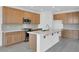 Modern kitchen with stainless steel appliances, gray tile floors, quartz countertops and wooden cabinets at 10912 E Tiburon Ave, Mesa, AZ 85212