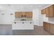 Bright kitchen with a large island, gray tile floors, stainless steel appliances, and ample cabinet space at 10912 E Tiburon Ave, Mesa, AZ 85212