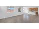 Open living room with tile flooring and views of the kitchen, dining, and outside through large windows at 10912 E Tiburon Ave, Mesa, AZ 85212