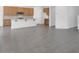 Open-concept living space featuring tile floors, flowing into a kitchen with an island and modern appliances at 10912 E Tiburon Ave, Mesa, AZ 85212