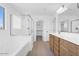 Spacious bathroom with glass-enclosed shower, soaking tub, double sink vanity, and tile floors at 10912 E Tiburon Ave, Mesa, AZ 85212