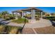 A covered pavilion features picnic tables and landscaping, perfect for outdoor gatherings and enjoying the community's green spaces at 10912 E Tiburon Ave, Mesa, AZ 85212
