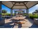 Community pavilion with picnic tables provides a shaded area for residents to gather and enjoy outdoor meals and social activities at 10912 E Tiburon Ave, Mesa, AZ 85212