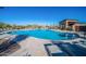 Large community pool with plenty of lounge chairs and an outdoor shower for residents to relax and enjoy the sunny weather at 10912 E Tiburon Ave, Mesa, AZ 85212