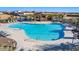 Aerial view of the community pool with lounge chairs and covered seating areas at 10912 E Tiburon Ave, Mesa, AZ 85212