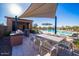 Poolside dining area with BBQ grills, shade and dining area at 10912 E Tiburon Ave, Mesa, AZ 85212