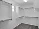 Walk-in closet with custom shelving, carpet, and ample storage space for organization at 10912 E Tiburon Ave, Mesa, AZ 85212