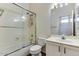 Bathroom features a glass-door shower over tub, white vanity, and modern fixtures at 11664 W Eagle Ct, Surprise, AZ 85378