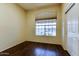 Bright bedroom featuring wood floors, a large window, and closet with paneled doors at 11664 W Eagle Ct, Surprise, AZ 85378
