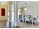 Dining room with arched doorways, tile flooring, and neutral color scheme at 11664 W Eagle Ct, Surprise, AZ 85378