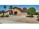Well-maintained property featuring desert landscaping, mature trees, and solar panels at 11664 W Eagle Ct, Surprise, AZ 85378