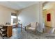 Bright home office with modern desk, comfortable seating, and tile flooring at 11664 W Eagle Ct, Surprise, AZ 85378