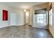Spacious living area with large windows, neutral walls, tile flooring, and modern lighting at 11664 W Eagle Ct, Surprise, AZ 85378