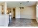 Open living room with tile flooring, ceiling fan, and arched doorways at 11664 W Eagle Ct, Surprise, AZ 85378